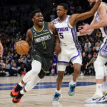 
              Minnesota Timberwolves guard Anthony Edwards (1) is fouled by Sacramento Kings guard De'Aaron Fox during the first half of an NBA basketball game Saturday, Jan. 28, 2023, in Minneapolis. (AP Photo/Craig Lassig)
            