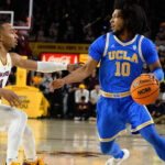 UCLA's Tyger Campbell (10) drives against Arizona State's Frankie Collins (10) during the first half of an NCAA college basketball game Thursday, Jan. 19, 2023, in Tempe, Ariz. (AP Photo/Darryl Webb)