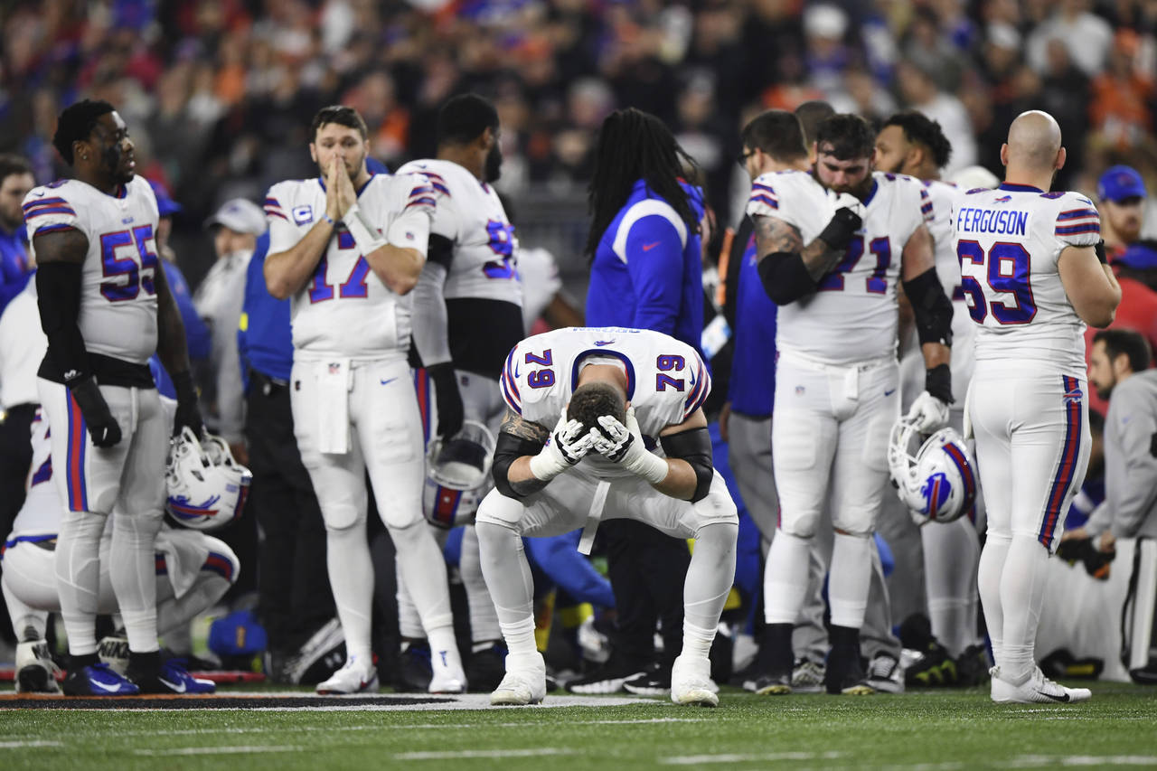 Buffalo Bills offensive tackle Spencer Brown (79) pauses as Damar Hamlin is examined by medical sta...
