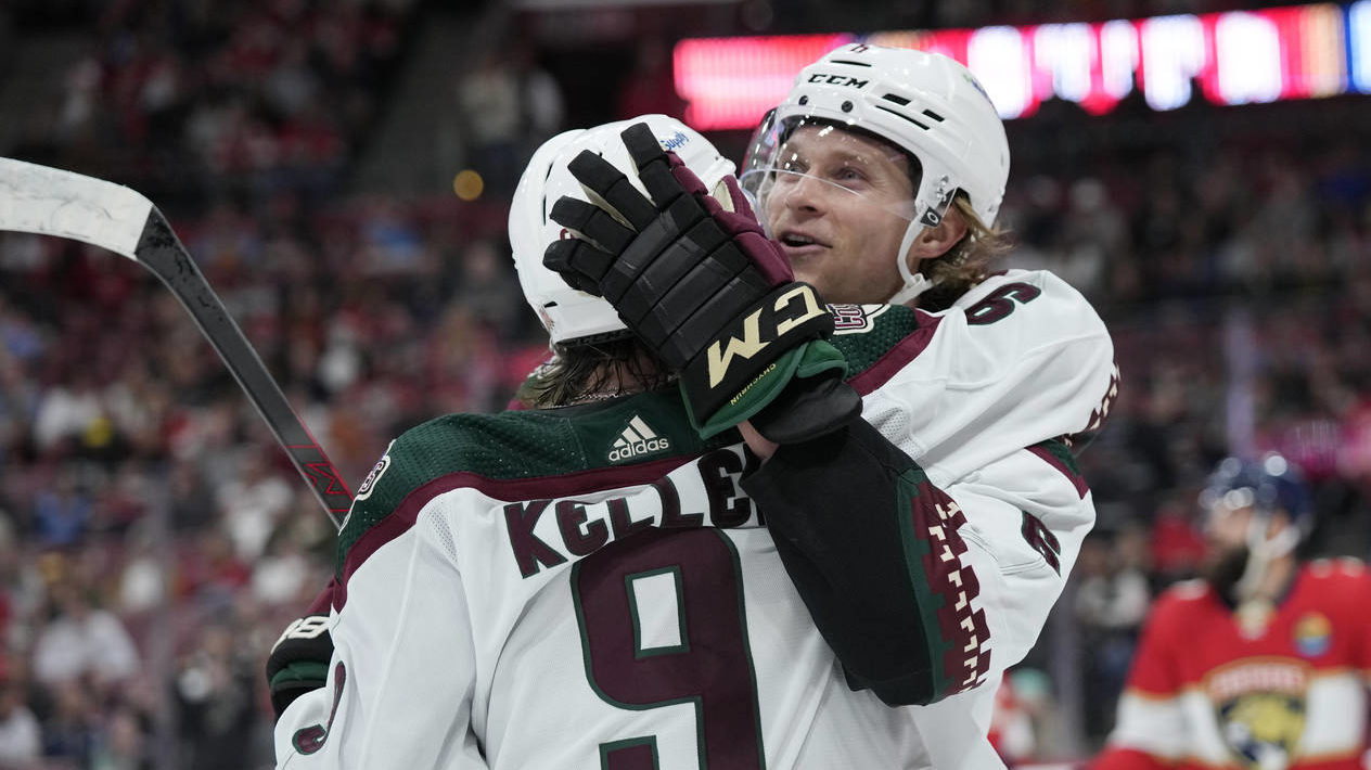 Arizona Coyotes defenseman Jakob Chychrun (6) celebrates with right wing Clayton Keller (9) after C...