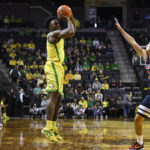 Oregon guard Jermaine Couisnard shoots over Arizona guard Kerr Kriisa (25) during the first half of an NCAA college basketball game Saturday, Jan. 14, 2023, in Eugene, Ore. (AP Photo/Andy Nelson)