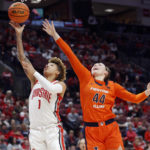 
              Ohio State guard Rikki Harris, left, shoots in front of Illinois forward Kendall Bostic during the second half of an NCAA college basketball game in Columbus, Ohio, Sunday, Jan. 8, 2023. (AP Photo/Paul Vernon)
            