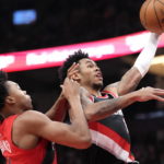 
              Portland Trail Blazers guard Anfernee Simons, right, drives to the net as Toronto Raptors forward Scottie Barnes, left, defends during first-half NBA basketball game action in Toronto, Sunday, Jan. 8, 2023. (Frank Gunn/The Canadian Press via AP)
            