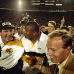 
              FILE - Colorado coach Bill McCartney, left, is escorted off the Orange Bowl field after the Buffaloes defeated Notre Dame, 10-9, in the 57th annual Orange Bowl Classic, in Miami, Jan. 1, 1991. By removing a potential stumbling block, Colorado has a chance to consistently win, just like in the days of Bill McCartney when the Buffaloes won their only national title.(AP Photo/Ray Fairall, File)
            