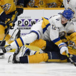 Buffalo Sabres center Tage Thompson (72) falls on Nashville Predators right wing Nino Niederreiter (22) as they chase the puck during the second period of an NHL hockey game Saturday, Jan. 14, 2023, in Nashville, Tenn. (AP Photo/Mark Zaleski)