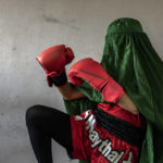 
              An Afghan woman who practices Muay Tha, or Thai boxing, poses for a photo in Kabul, Afghanistan, Saturday, Oct. 29, 2022. The ruling Taliban have banned women from sports as well as barring them from most schooling and many realms of work. A number of women posed for an AP photographer for portraits with the equipment of the sports they loved. Though they do not necessarily wear the burqa in regular life, they chose to hide their identities with their burqas because they fear Taliban reprisals and because some of them continue to practice their sports in secret. (AP Photo/Ebrahim Noroozi)
            