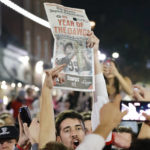 A Georgia football fan holds a newspaper while celebrating after the NCAA College Football Playoff national championship game against TCU, Monday, Jan. 9, 2023, in Athens, Ga. (AP Photo/Alex Slitz)