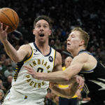 Indiana Pacers' T.J. McConnell drives to the basket against Milwaukee Bucks' AJ Green during the first half of an NBA basketball game, Monday, Jan. 16, 2023, in Milwaukee. (AP Photo/Aaron Gash)