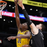 Los Angeles Lakers center Thomas Bryant, left, and Los Angeles Clippers center Ivica Zubac go after a rebound during the first half of an NBA basketball game Tuesday, Jan. 24, 2023, in Los Angeles. (AP Photo/Mark J. Terrill)