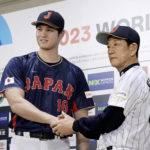 
              Shohei Ohtani, left, of Los Angeles Angels, shakes hands with Japan's manager Hideki Kuriyama, right, during a press conference in Tokyo, Japan, Friday, Jan. 6, 2023. Japan officials on Friday named 12 members of the World ,Baseball Classic team that will represent the country. The World Baseball Classic will be played March 8-21.(Iori Sagisawa/Kyodo News via AP)
            