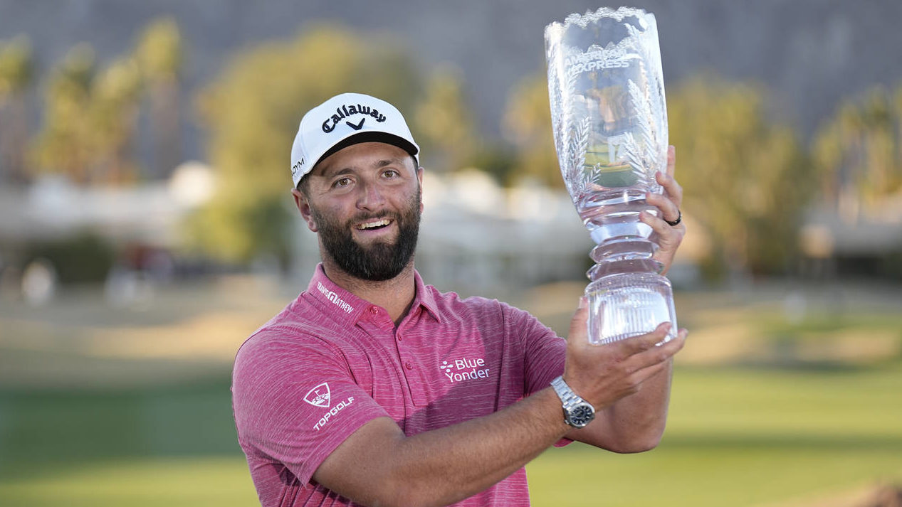 Jon Rahm hold the winner's trophy after the American Express golf tournament on the Pete Dye Stadiu...