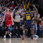 Indiana Pacers guard Bennedict Mathurin (00) celebrates his three-point basket as Chicago Bulls guard Alex Caruso (6) reacts during the second half of an NBA basketball game in Indianapolis, Tuesday, Jan. 24, 2023. The Pacers defeated the Bulls 116-110. (AP Photo/Michael Conroy)