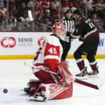 Detroit Red Wings goaltender Magnus Hellberg (45) gives up a goal to Arizona Coyotes' Travis Boyd as Coyotes defenseman Juuso Valimaki (4) skates past during the third period of an NHL hockey game in Tempe, Ariz., Tuesday, Jan. 17, 2023. The Coyotes won 4-3 in a shootout. (AP Photo/Ross D. Franklin)
