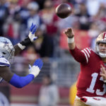 San Francisco 49ers quarterback Brock Purdy (13) passes as Dallas Cowboys defensive end DeMarcus Lawrence (90) applies pressure during the first half of an NFL divisional round playoff football game in Santa Clara, Calif., Sunday, Jan. 22, 2023. (AP Photo/Tony Avelar)