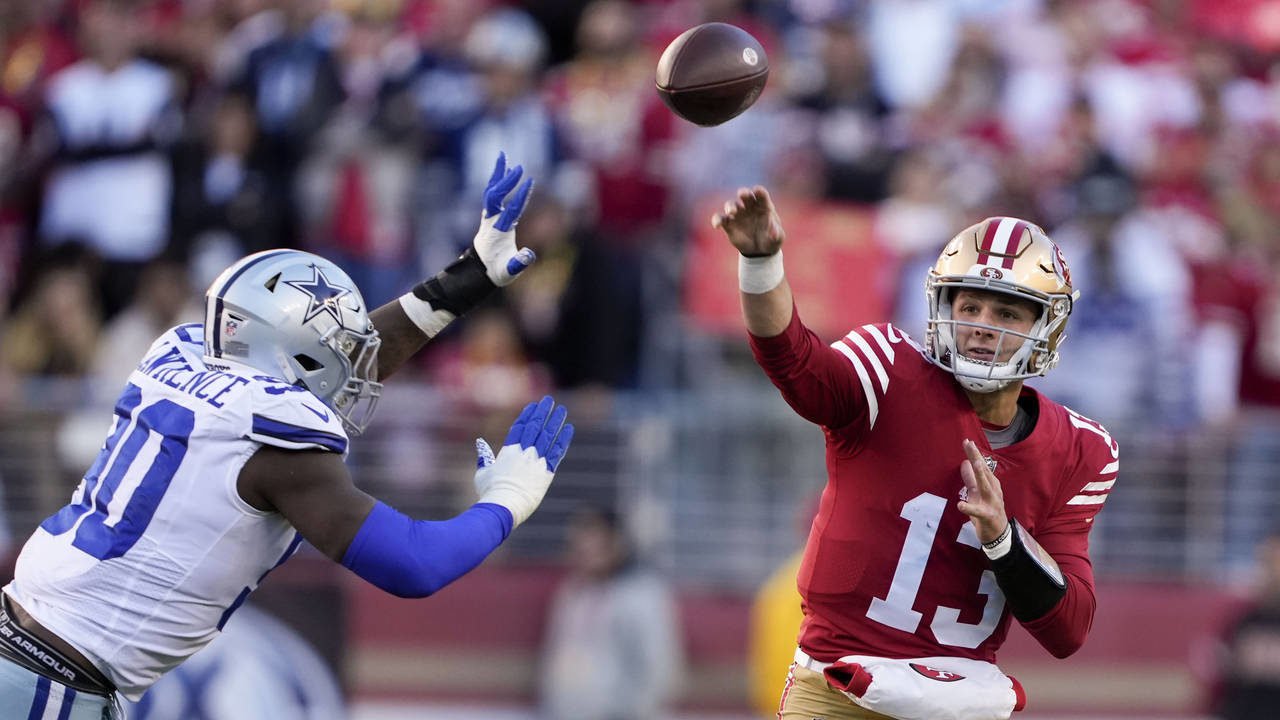 San Francisco 49ers quarterback Brock Purdy (13) passes as Dallas Cowboys defensive end DeMarcus La...
