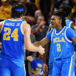 UCLA's Jamie Jaquez Jr. (24) is greeted by Dylan Andrews (2) after hitting a 3-pointer against Arizona State late in the second half of an NCAA college basketball game Thursday, Jan. 19, 2023, in Tempe, Ariz. UCLA won 74-62. (AP Photo/Darryl Webb)