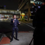 A television reporter broadcasts in front of University of Cincinnati Medical Center, Monday, Jan. 2, 2023, in Cincinnati, where Buffalo Bills' Damar Hamlin was taken after collapsing on the field during an NFL football game against the Cincinnati Bengals. (AP Photo/Jeff Dean)