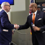 Chicago Bears Chairman George H. McCaskey, left, shakes hands with new President & CEO Kevin Warren during an NFL football news conference at Halas Hall in Lake Forest, Ill., Tuesday, Jan. 17, 2023.  (AP Photo/Nam Y. Huh)
