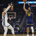 
              Golden State Warriors guard Stephen Curry, right, shoots a 3-point basket over Memphis Grizzlies forward Dillon Brooks during the first half of an NBA basketball game in San Francisco, Wednesday, Jan. 25, 2023. (AP Photo/Godofredo A. Vásquez)
            
