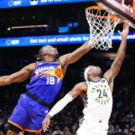
              Phoenix Suns' Bismack Biyombo (18) blocks a shot by Indiana Pacers' Buddy Field (24) during the first half of an NBA basketball game in Phoenix, Saturday, Jan. 21, 2023. (AP Photo/Darryl Webb)
            