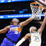 
              Phoenix Suns' Bismack Biyombo (18) blocks a shot by Indiana Pacers' Buddy Field (24) during the first half of an NBA basketball game in Phoenix, Saturday, Jan. 21, 2023. (AP Photo/Darryl Webb)
            