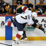 
              Florida Panthers' Radko Gudas (7) checks Pittsburgh Penguins' Jason Zucker into the boards during the first period of an NHL hockey game in Pittsburgh, Tuesday, Jan. 24, 2023. (AP Photo/Gene J. Puskar)
            