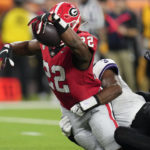 Georgia running back Branson Robinson (22) falls into the end zone against TCU safety Mark Perry (3) during the second half of the national championship NCAA College Football Playoff game, Monday, Jan. 9, 2023, in Inglewood, Calif. (AP Photo/Ashley Landis)