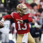 San Francisco 49ers quarterback Brock Purdy (13) passes against the Seattle Seahawks during the first half of an NFL wild card playoff football game in Santa Clara, Calif., Saturday, Jan. 14, 2023. (AP Photo/Josie Lepe)