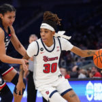 
              St. John's Kadaja Bailey (30) drives past Connecticut's Azzi Fudd (35) during the first half of an NCAA basetball game Wednesday, Jan. 11, 2023, in New York. (AP Photo/Frank Franklin II)
            