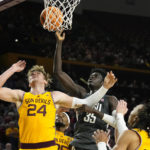 Washington State forward Mouhamed Gueye (35) grabs a rebound over Arizona State forward Duke Brennan (24) as Arizona State guard Frankie Collins, right, watches during the first half of an NCAA college basketball game in Tempe, Ariz., Thursday, Jan. 5, 2023. (AP Photo/Ross D. Franklin)