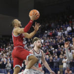 
              Loyola Marymount guard Cam Shelton, left, shoots the go-ahead basket in front of Gonzaga guard Malachi Smith, right, and forward Drew Timme during the second half of an NCAA college basketball game, Thursday, Jan. 19, 2023, in Spokane, Wash. Loyola Marymount won 68-67. (AP Photo/Young Kwak)
            