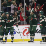 Minnesota Wild center Frederick Gaudreau (89) is congratulated by Ryan Hartman (38), Marcus Foligno (17) and Sam Steel (13) during the second period of the team's NHL hockey game against the Arizona Coyotes on Saturday, Jan. 14, 2023, in St. Paul, Minn. (AP Photo/Andy Clayton-King)