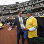 FILE - Oakland Athletics President Dave Kaval, left, talks to Reggie Jackson during a celebration of the Athletics' 1972 World Series winning team before a baseball game between the Athletics and the Boston Red Sox in Oakland, Calif., June 4, 2022. The Oakland Athletics have spent years trying to get a new stadium while watching Bay Area neighbors the Giants, Warriors, 49ers and Raiders successfully move into state-of-the-art venues, and now time is running short on their efforts. (AP Photo/Jeff Chiu, File)