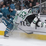 
              Dallas Stars defenseman Esa Lindell (23) is checked into the boards by San Jose Sharks center Michael Eyssimont (21) during the first period of an NHL hockey game Wednesday, Jan. 18, 2023, in San Jose, Calif. (AP Photo/Tony Avelar)
            