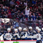 Winnipeg Jets center Mark Scheifele (55) celebrates after a goal with the bench during second-period NHL hockey game action against the Ottawa Senators in Ottawa, Ontario, Saturday, Jan. 21, 2023. (Sean Kilpatrick/The Canadian Press via AP)