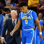 UCLA coach Mick Cronin gives advice to Jaylen Clark (0) during the second half of the team's NCAA college basketball game against Arizona State, Thursday, Jan. 19, 2023, in Tempe, Ariz. UCLA won 74-62. (AP Photo/Darryl Webb)