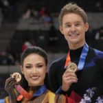 Madison Chock, left, and Evan Bates hold up their medals after the free dance at the U.S. figure skating championships in San Jose, Calif., Saturday, Jan. 28, 2023. Chock and Bates finished first in the event. (AP Photo/Tony Avelar)