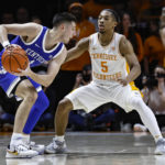 
              Kentucky guard CJ Fredrick (1) looks to pass as Tennessee guard Zakai Zeigler (5) defends during the first half of an NCAA college basketball game Saturday, Jan. 14, 2023, in Knoxville, Tenn. (AP Photo/Wade Payne)
            