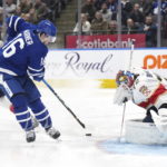 
              Toronto Maple Leafs forward Mitchell Marner (16) passes the puck in front of Florida Panthers goaltender Sergei Bobrovsky (72) during the second period of an NHL hockey game Tuesday, Jan. 17, 2023, in Toronto. (Nathan Denette/The Canadian Press via AP)
            