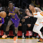 
              Los Angeles Lakers' Dennis Schroder (17) drives past Atlanta Hawks' Dejounte Murray during the first half of an NBA basketball game Friday, Jan. 6, 2023, in Los Angeles. (AP Photo/Jae C. Hong)
            