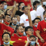 FILE - Chinese soccer fans shout after their national team lost from Saudi Arabia during their match of the Asian zone group B qualifying soccer match for the FIFA World Cup Qatar 2022 at the King Abdullah sports city stadium, in Jiddah, Saudi Arabia, on Oct. 12, 2021. After three years of isolation and financial struggles in Chinese soccer the country is reopening its borders and economy to the outside world. With it, frustrated fans, financially-challenged clubs and unpaid players in the Chinese Super League might receive some long-awaited good news.(AP Photo/Amr Nabil, File)