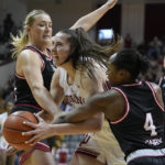 
              Indiana's Mackenzie Holmes, center, is double-teamed by Nebraska's Alexis Markowski, left, and Sam Haiby during the second half of an NCAA college basketball game, Sunday, Jan. 1, 2023, in Bloomington, Ind. (AP Photo/Darron Cummings)
            