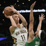New Orleans Pelicans guard Dyson Daniels (11) is pressured by Boston Celtics guard Derrick White (9) on a drive to the basket during the first half of an NBA basketball game, Wednesday, Jan. 11, 2023, in Boston. (AP Photo/Charles Krupa)