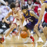 
              Indiana guard Trey Galloway, left, attempts to steal the ball from Northwestern guard Boo Buie (0) during the second half of an NCAA college basketball game, Sunday, Jan. 8, 2023, in Bloomington, Ind. (AP Photo/Doug McSchooler)
            
