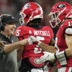 Georgia tight end Brock Bowers (19) celebrates his touchdown with Georgia head coach Kirby Smart during the second half of the national championship NCAA College Football Playoff game against TCU, Monday, Jan. 9, 2023, in Inglewood, Calif. (AP Photo/Ashley Landis)