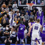 
              Sacramento Kings guard De'Aaron Fox (5) dunks against Utah Jazz forward Jarred Vanderbilt (8) during the second half of an NBA basketball game Tuesday, Jan. 3, 2023, in Salt Lake City. (AP Photo/Jeff Swinger)
            