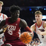 
              Washington State's Mouhamed Gueye (35) looks to get out of a double-team by Arizona's Azuolas Tubelis, left, and Pelle Larsson, right, during the first half of an NCAA college basketball game, Saturday, Jan. 7, 2023, in Tucson, Ariz. (AP Photo/Darryl Webb)
            