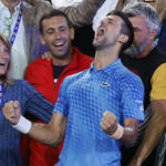
              Novak Djokovic of Serbia, center, celebrates with his team including his mother, Dijana, left, after defeating Stefanos Tsitsipas of Greece in the men's singles final at the Australian Open tennis championships in Melbourne, Australia, Sunday, Jan. 29, 2023. (AP Photo/Asanka Brendon Ratnayake)
            