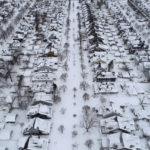 
              FILE - Fordham Avenue, center, and the 1901 Pan-American Exposition neighborhood of Buffalo, N.Y. is coated in a blanket of snow after a blizzard, Tuesday, Dec. 27, 2022. The Buffalo Bills have been a reliable bright spot for a city that has been shaken by a racist mass shooting and back-to-back snowstorms in recent months. So when Bills safety Damar Hamlin was critically hurt in a game Monday, the city quickly looked for ways to support the team. (Derek Gee /The Buffalo News via AP, File)/The Buffalo News via AP)
            
