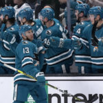 San Jose Sharks center Nick Bonino (13) is congratulated by teammates after scoring a goal against the Dallas Stars during the second period of an NHL hockey game Wednesday, Jan. 18, 2023, in San Jose, Calif. (AP Photo/Tony Avelar)